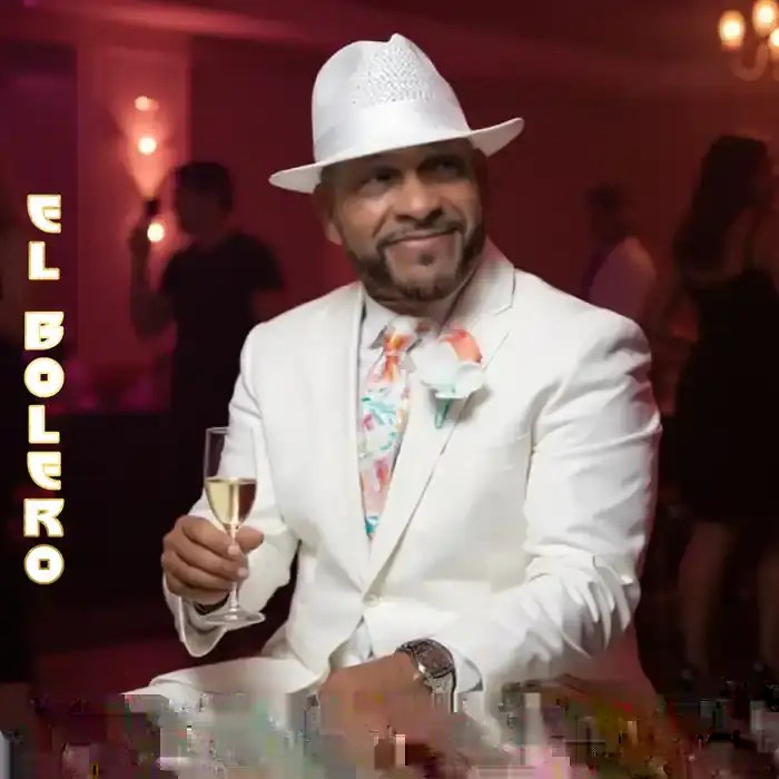 Chello Hollyday in a white suit and hat