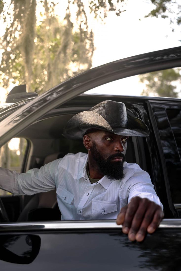 Jesse Daniels leaning out of a black pickup truck window
